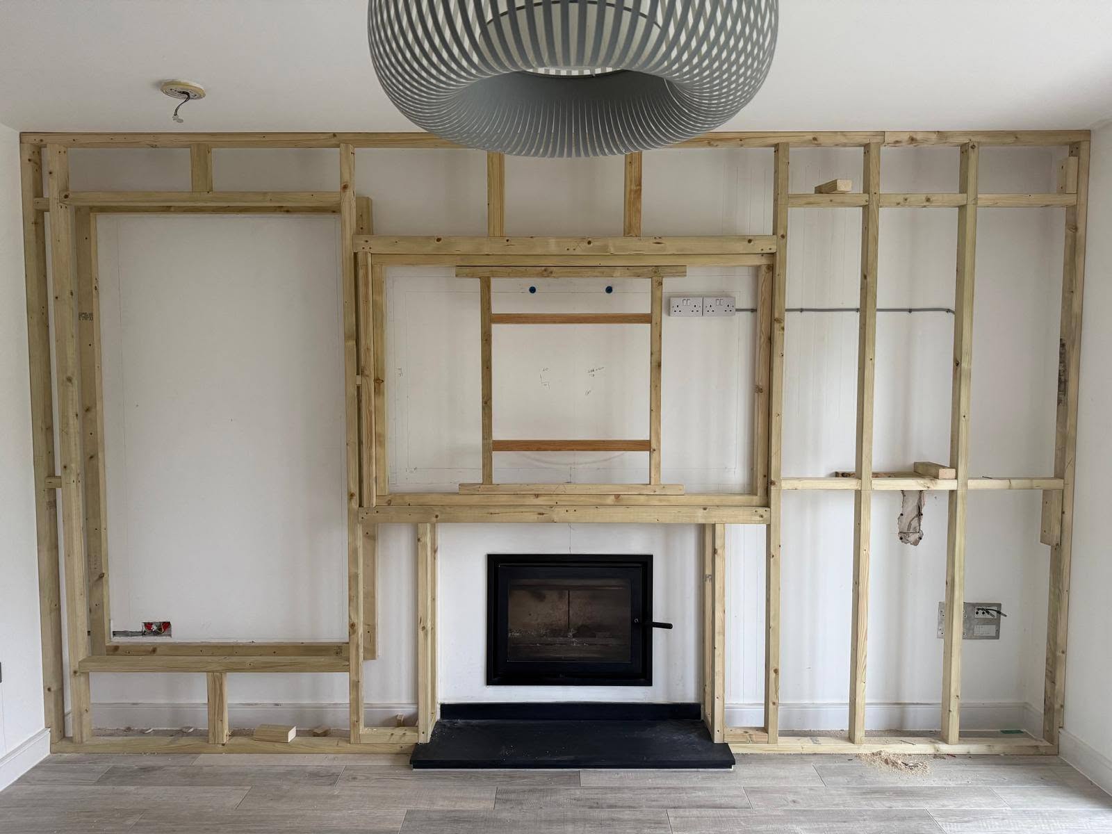 Timber stud framing built around a wood burner