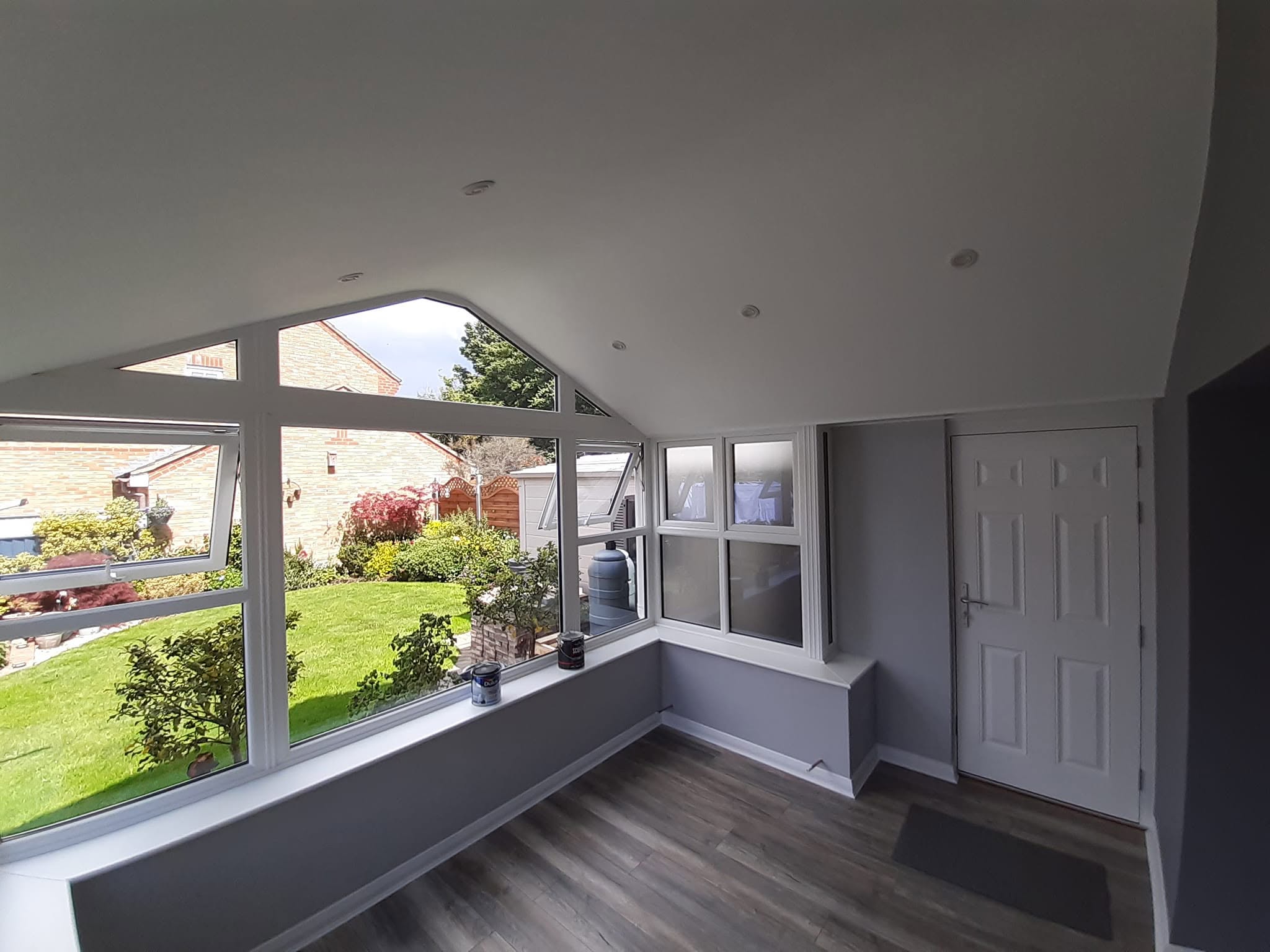 Conservatory room painted grey with white trim
