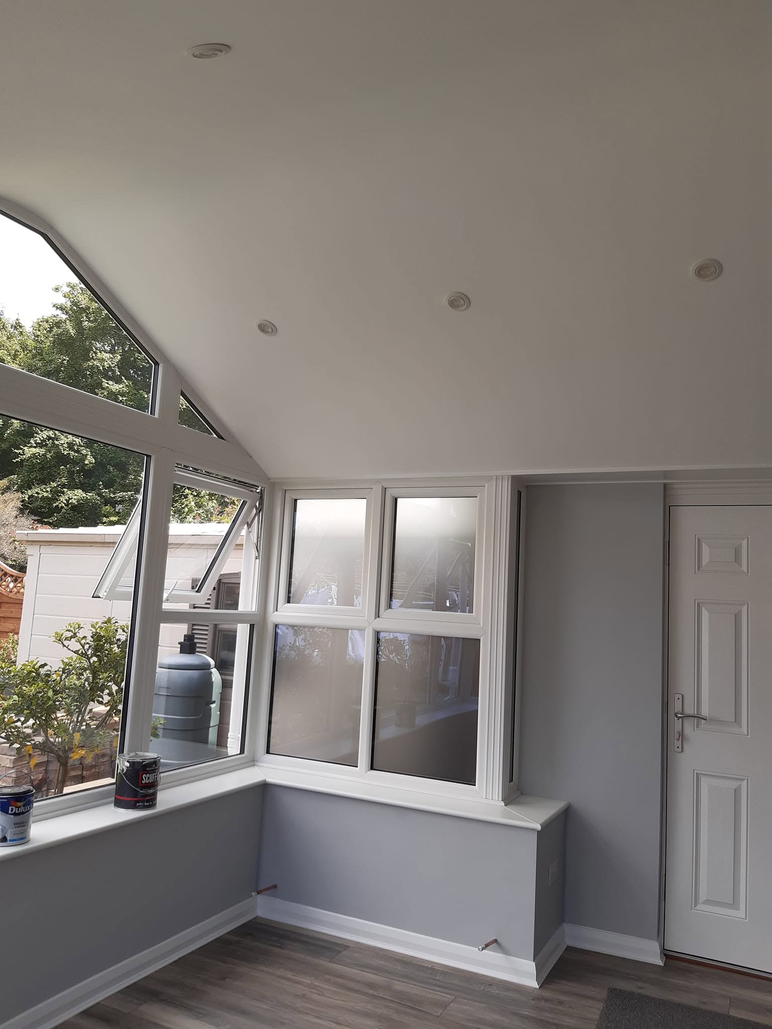 Grey garden room with white window boards and trims