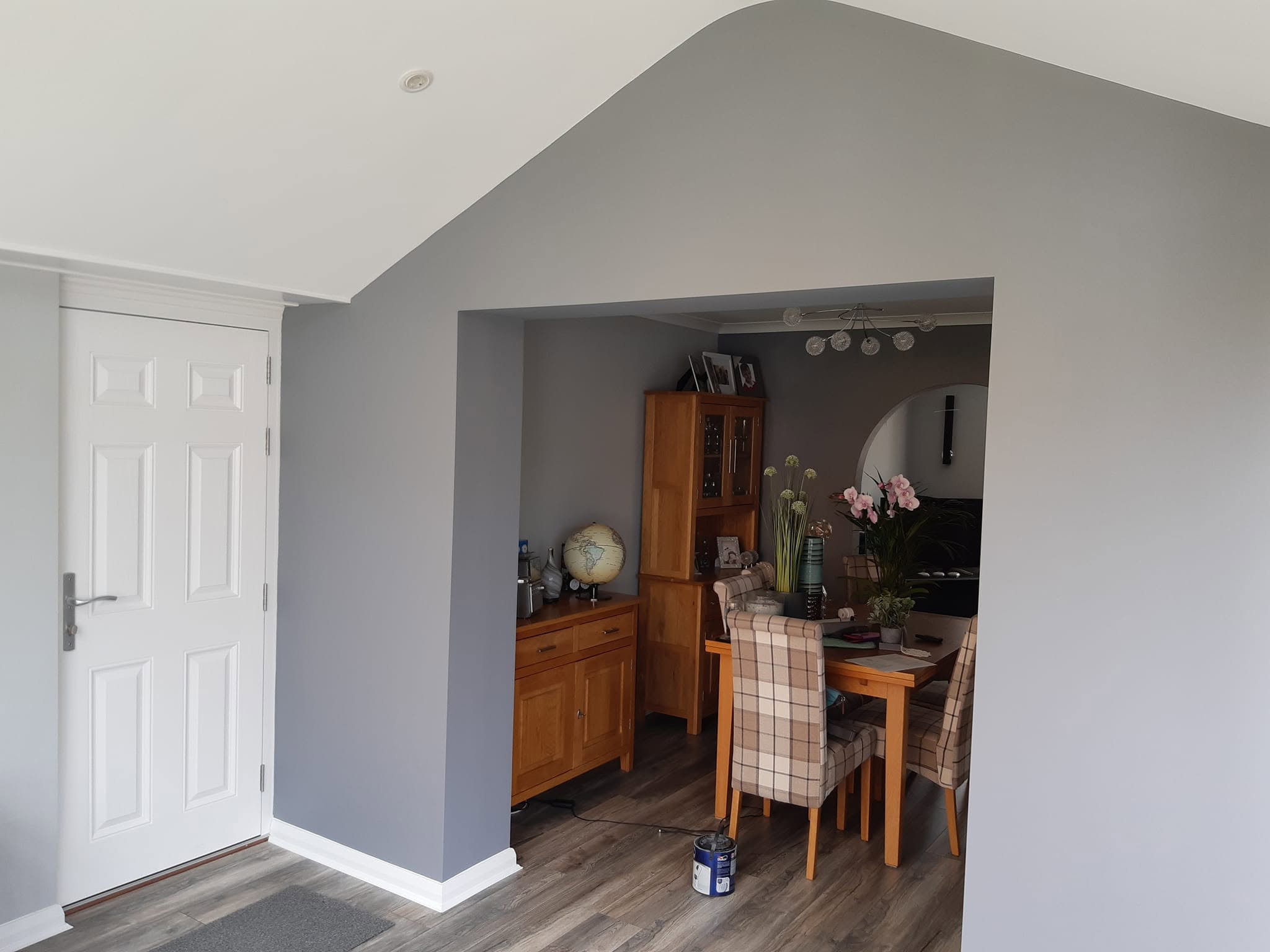 Grey painted opening through to a dining area