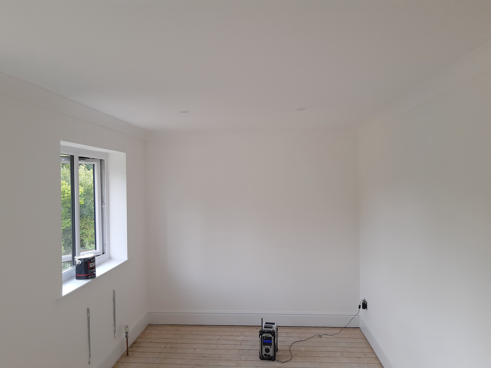 Freshly painted empty white room with a new window