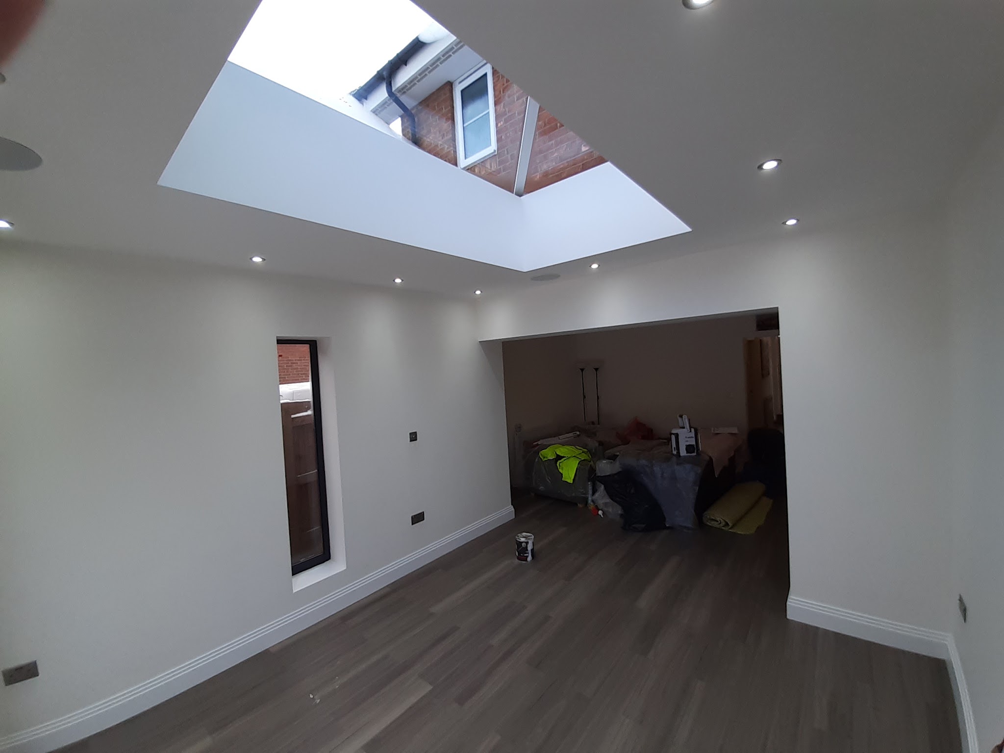 Kitchen diner extension finished in white under a lantern roof light