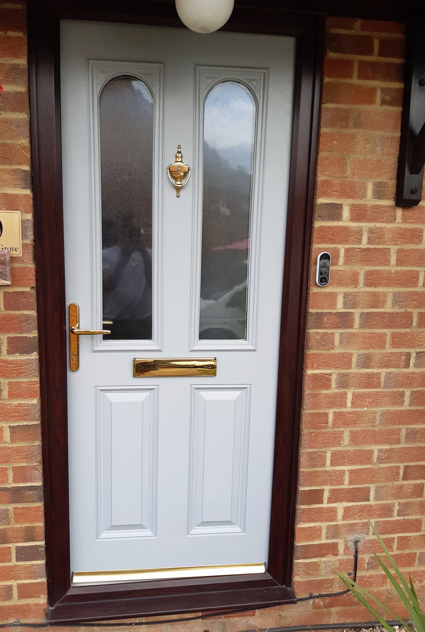 Freshly painted front door set in a brick wall